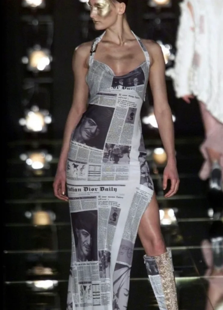 Dior Fall 2000 RTW "Fly Girl" — newspaper-print bias-cut slip dress on the runway