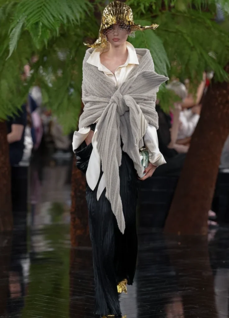 Opening look — grey knit knotted over black plissé