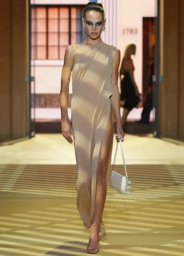 Gucci Spring 2027 Look 43
— nude asymmetric draped gown with small white bag
