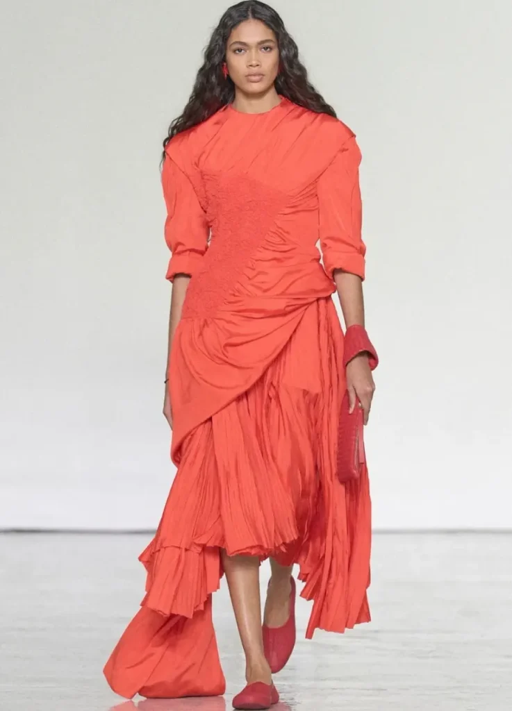 Bottega Veneta Spring 2027 Look 55,
red cotton dress with ruched waist, side knot and asymmetric pleated skirt