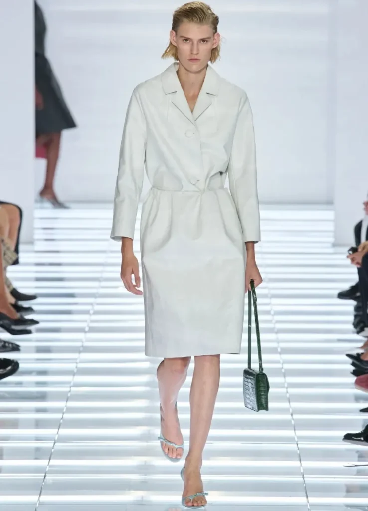 Prada Spring 2027 Look 13 
— white belted coat silhouette